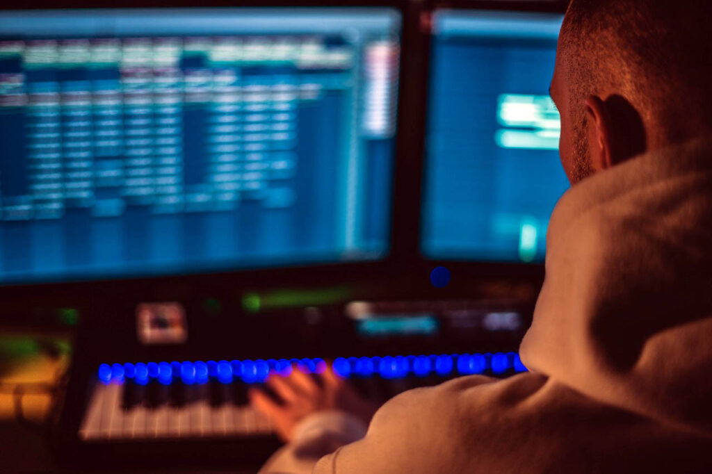 Photograph of a music producer making a cover song with an electronic keyboard